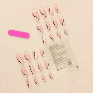 Pink and white marble press-on nails with gold accents and manicure tool set