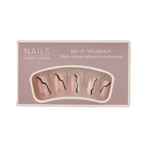 Press-on nails set in nude pink with marble gold texture in a window box package