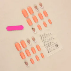 Short yellow minimalist press-on nails set with orange tones and crystal rhinestone accents