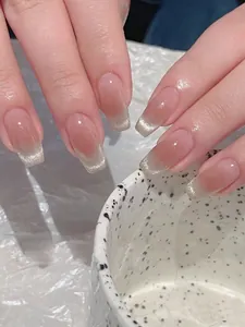Detailansicht der nudefarbenen Press-On-Nägel mit silbernen Cat-Eye-French-Tips, lange eckig