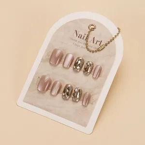 Handmade champagne cat-eye press-on nails with sparkling rhinestones and glitter