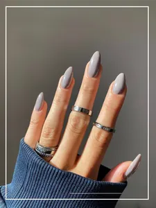 Detail of medium-long almond grey-purple press-on nails with a glossy finish