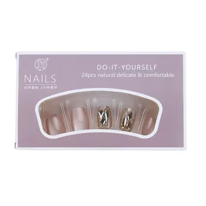 Short nude pink cat eye press-on nails set with rhinestones in a purple gift box