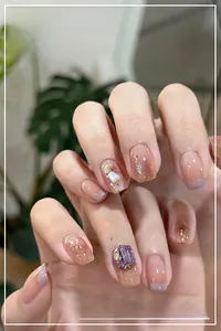 Detail of lavender French tip press-on nails with 3D rhinestones and silver glitter