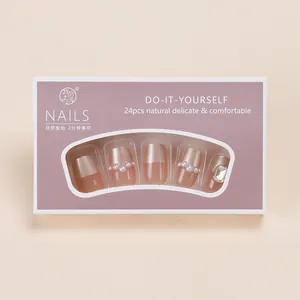 Short mauve press-on nails with french gold tips, elegant pearls and sparkling rhinestones