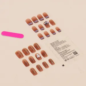 Handmade press-on nails with nude gradient, gold foil, and heart 3D rhinestones