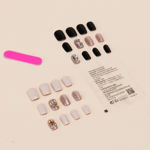 Handmade press-on nail kit in black and beige with glitter rhinestones and a pink nail file