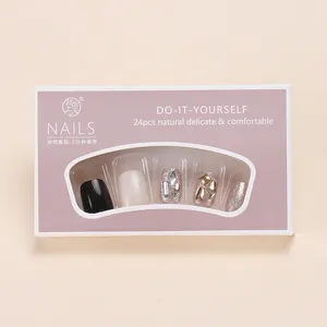 DIY black press-on nails set with glitter accents in windowed purple packaging