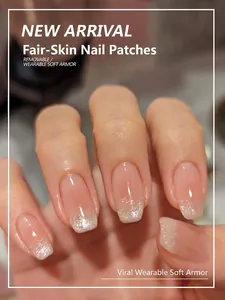 Detail of short square press-on nails with nude pink gradient and silver glitter tips