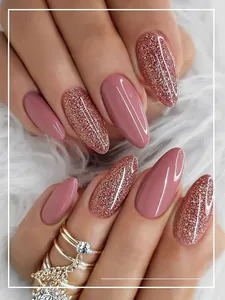 Detail view of pink glossy and rose gold glitter press-on nails on soft white fur