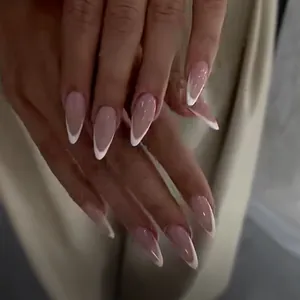 Almond-shaped press-on nails with nude base and white French gradient tips for women