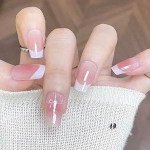 Pink and white gradient press-on nails with French tips and butterfly bow design