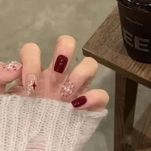 Short square burgundy handmade press-on nails with silver glitter and red star designs
