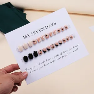 Short square press-on nails set with black french tip, heart patterns and pearls
