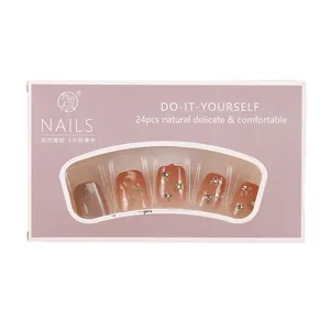 Handgemaakte kunstnagels met champagne cat-eye bloemdessins in oranje en grijs verloop