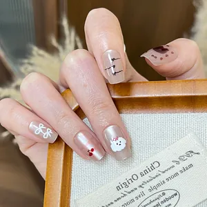 Detailed view of nude pink press-on nails with 3D bow, cherry, and puppy designs