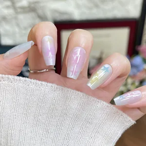 Short trapezoid press-on nails with macaron rainbow gradient and shimmering star motifs