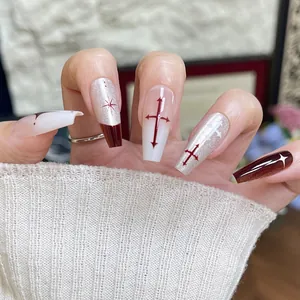 Detail of red and white gradient coffin nails with gothic cross and star pattern designs