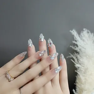 Luxury long almond press-on nails with nude pink gradient, silver glitter and rhinestones