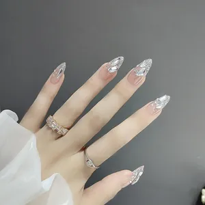 Handmade long almond press-on nails with shiny rhinestones and silver glitter gradient