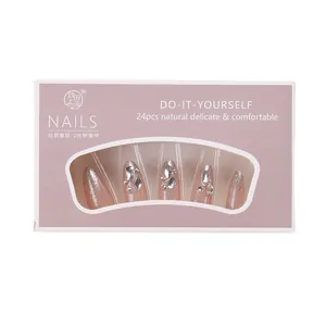 Handmade almond press-on nails in nude pink with silver glitter and rhinestone accents