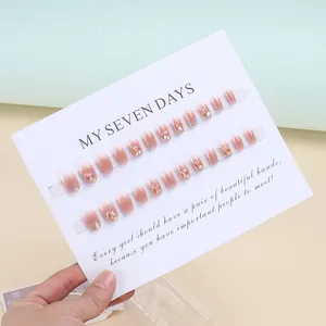 Handmade pink gradient press-on nails with luxury rhinestones and glitter on display card