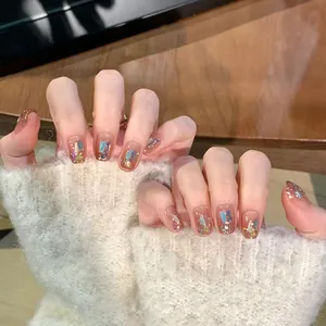 Close-up of short square nails with nude base, colorful sequins, and gold glitter detail