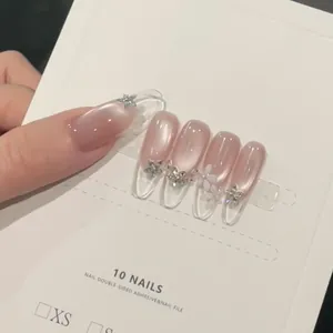 Cat eye press-on nails with nude pink gradient, silver floral accents and crystals