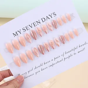 Detail of 24pcs coffin press-on nails featuring rose gold glitter and marble textures