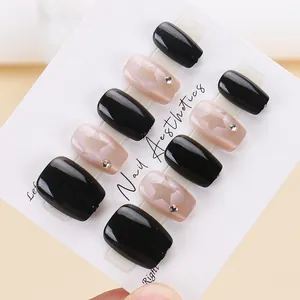 Star pattern cat-eye press-on nails with black and pink finish in a 10-piece set