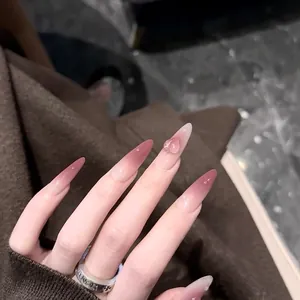 Long stiletto press-on nails with pink gradient, 3D water drop decor and glitter finish