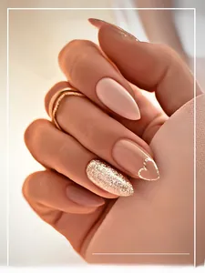Detailed view of almond shaped press-on nails with glitter, heart patterns, and nude pink finish