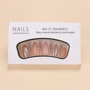 Pink French press-on nails with champagne glitter and diamond accents in window box