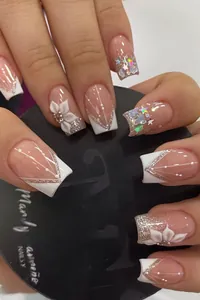 Macro detail of French square nails with 3D white flowers and silver glitter stars