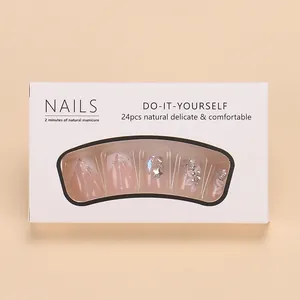French press-on nails set with glitter stars and white floral patterns in 24 piece packaging