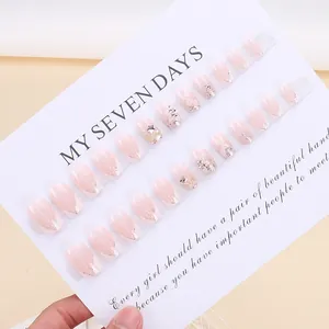 French style press-on nails with pink gradient, silver glitter, and star detail design