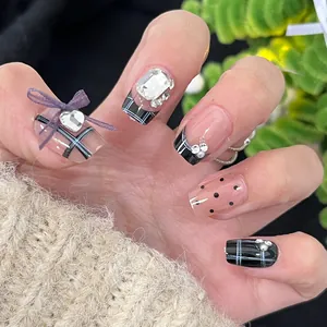 Cat eye press-on nails featuring black and white French grid with purple ribbon bows