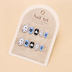 Detail of cute flower nail tips for girls in light blue and black heart patterns