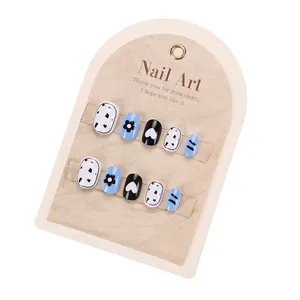 Kids press-on nails set with blue floral and heart patterns on a display card