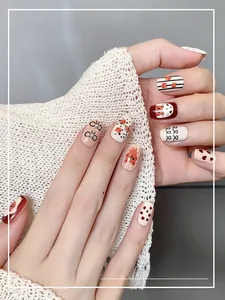 Detail of handmade bear cartoon press-on nails with 3D pearls and bow accents
