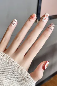 Detailed view of handmade cartoon bear press-on nails with 3D pearl bow and cute patterns