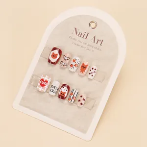 Close-up of handmade press-on nails with cute bear, heart patterns and polished finish
