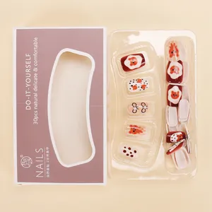 Detail of cute bear and bow press-on nails with 3D pearls and polka dot patterns