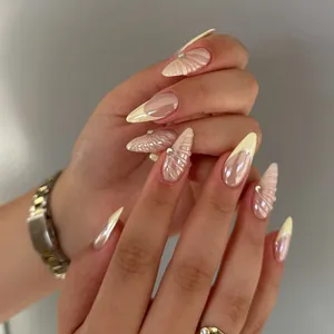 Long almond press-on nails with yellow French tips, 3D shell texture and rhinestones