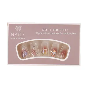 Cat eye press-on nails with 3D floral accents and jewels in a 30-piece box set