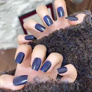 Deep blue cat-eye press-on nails with shimmering finish on square oval shaped nails
