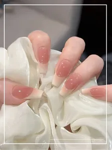Close-up of elegant square blush gradient french press-on nails with white tips