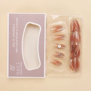 Detail of ombre cat-eye press-on nails with rhinestones in a purple gift box packaging