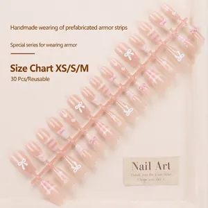 Pink handmade press-on nails with bow and heart accents, set of 30 pieces in sizes XS-M
