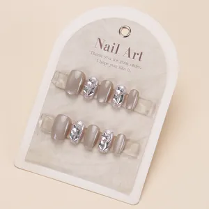 Short square press-on nails in cat-eye grey brown with 3D star rhinestones